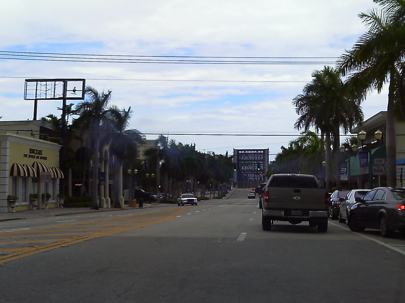 Atlantic Avenue through downtown Delray Beach, with its shops and the Intracoastal drawbridge ahead.