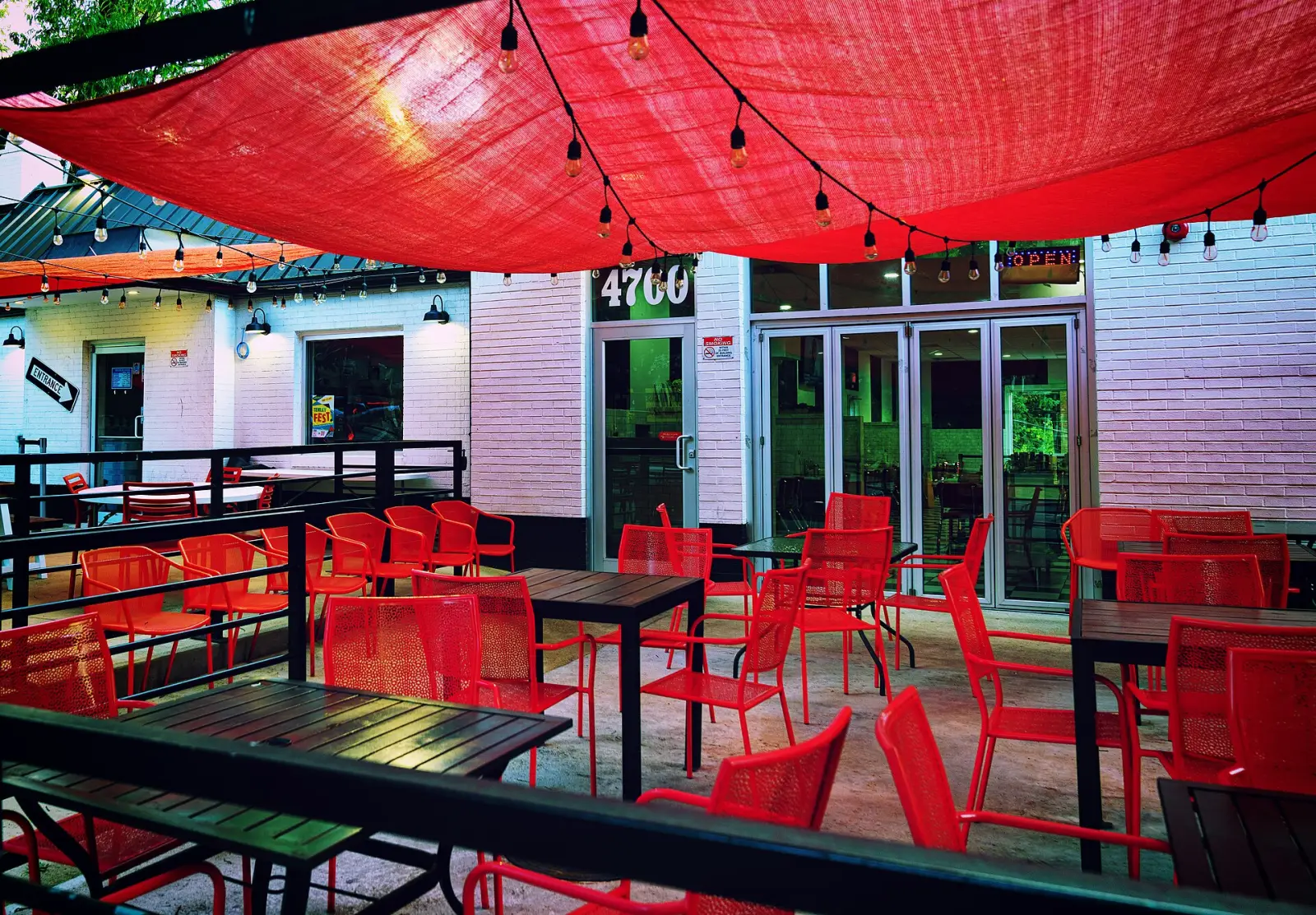 Tables and chairs on a sidewalk cafe patio. The photo was not taken in Boynton Beach.