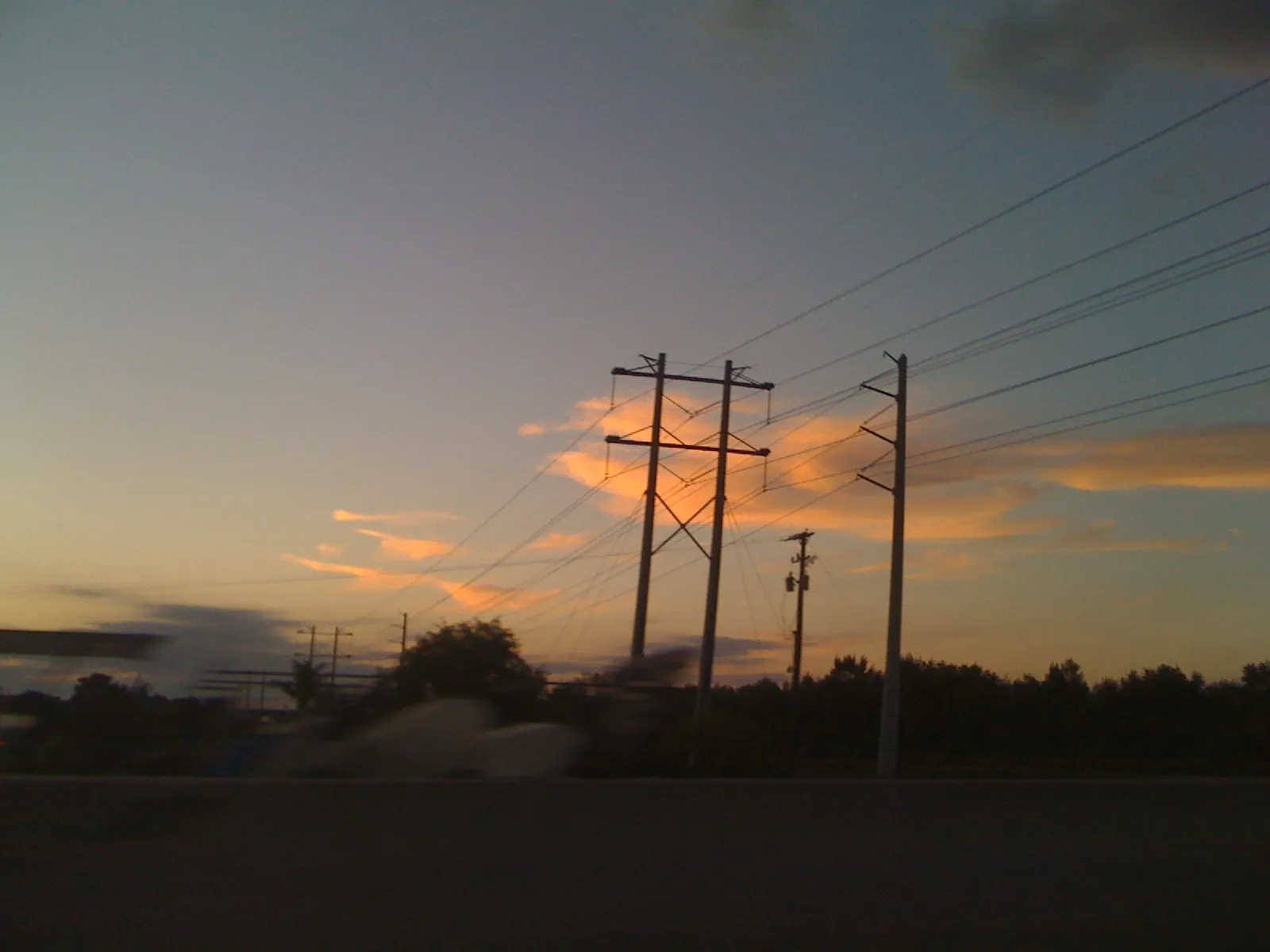 Power lines against the sunset west of Boynton Beach in Palm Beach County.